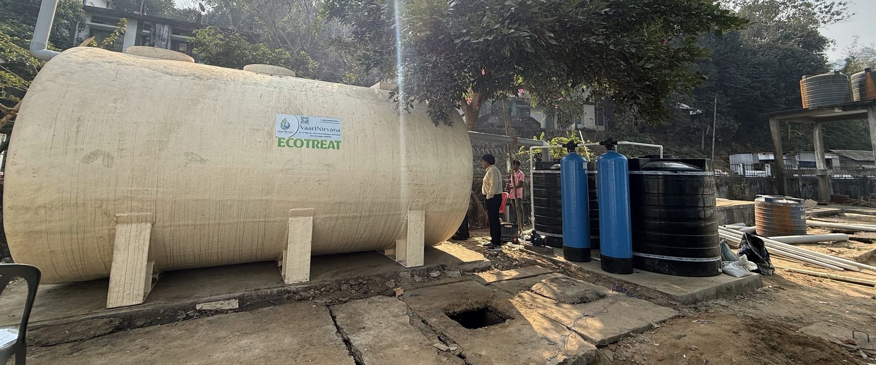 The EcoTreat tank at Baghmara with its two blue tertiary filters and storage tanks beside it.